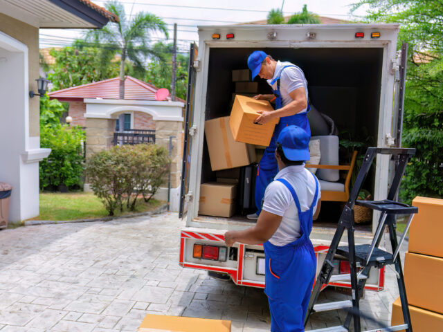Professional goods move service use truck carry personal belongings door to door transport delivery handover boxes luggage one by one and keep stack on the floor before transfer to place in house